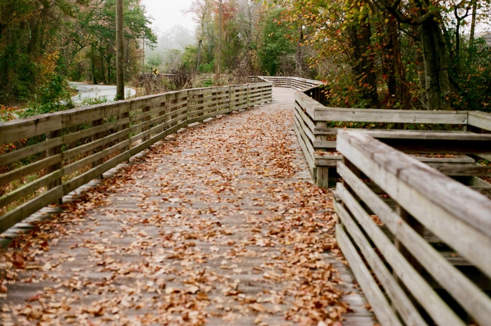 a wooden bridge with a railing