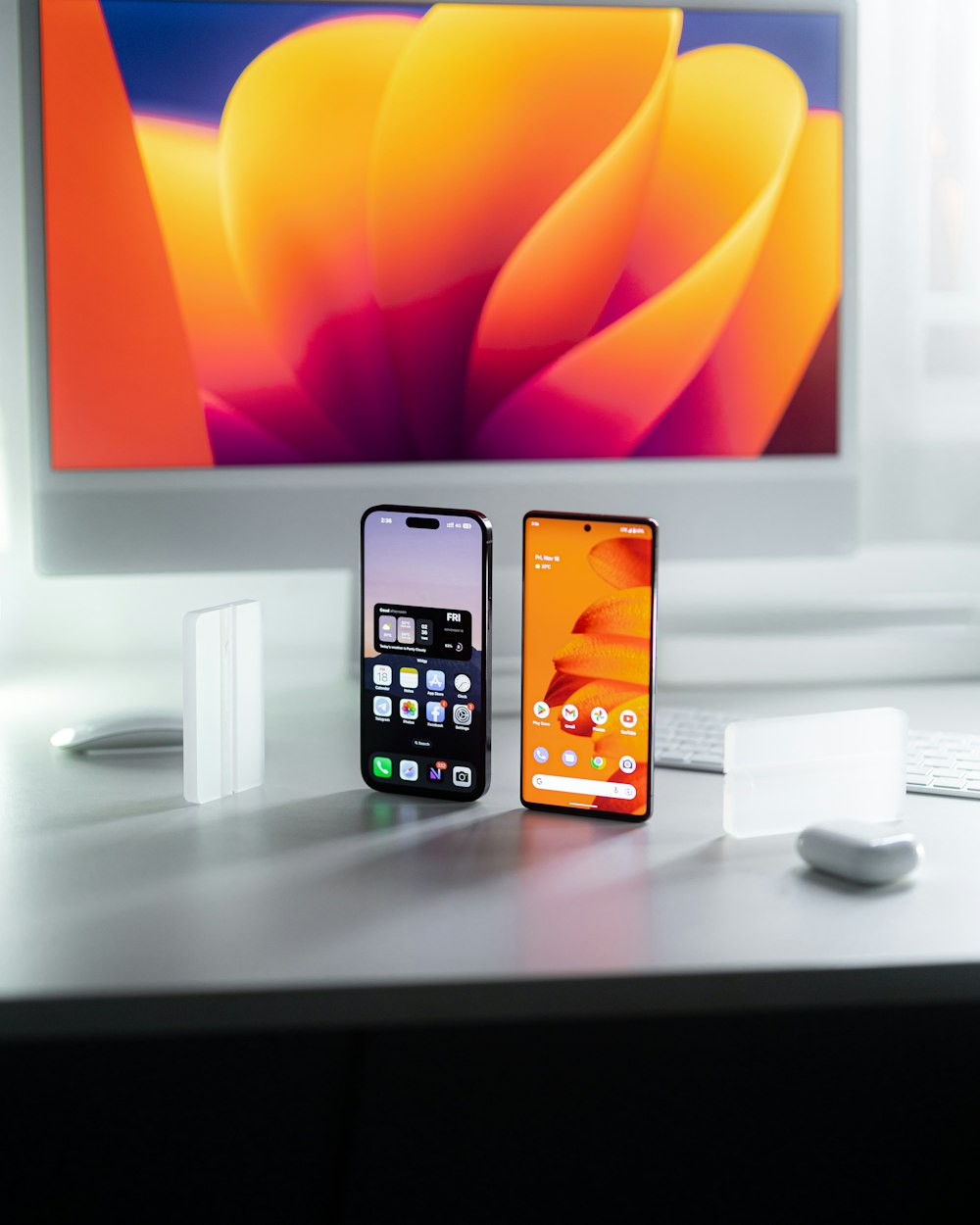 a couple of cell phones on a desk