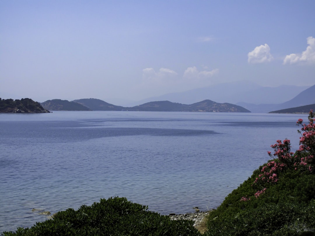 a body of water with hills in the background,