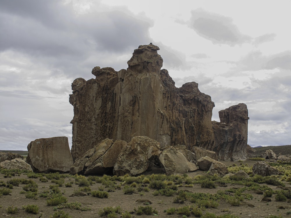 a rocky mountain with a cloudy sky