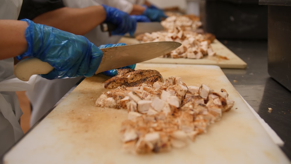 a person cutting meat