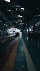 a train station with people waiting