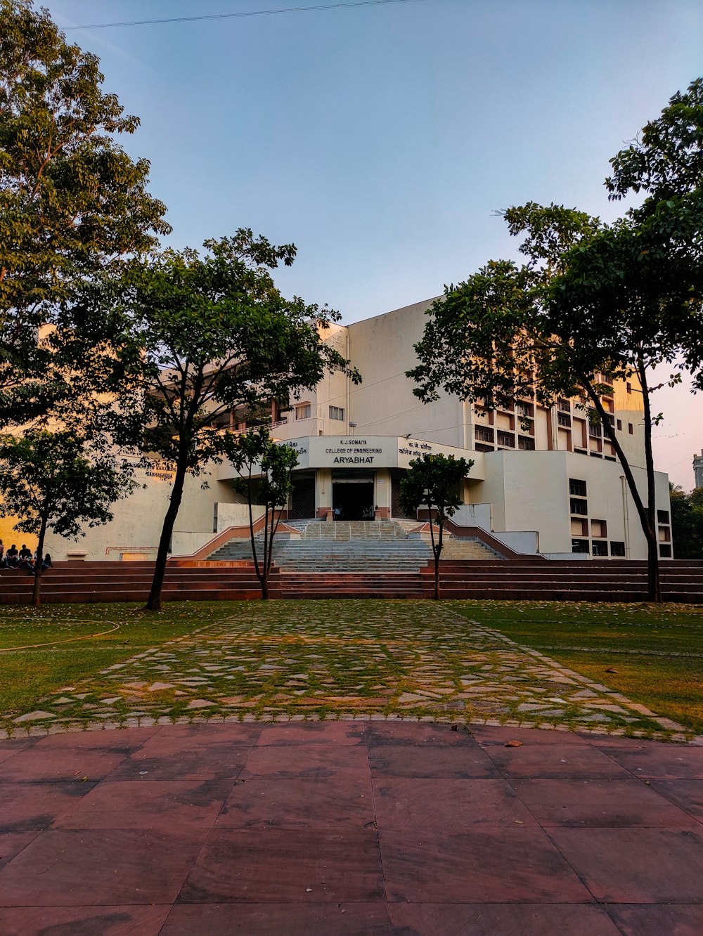 a building with trees and grass