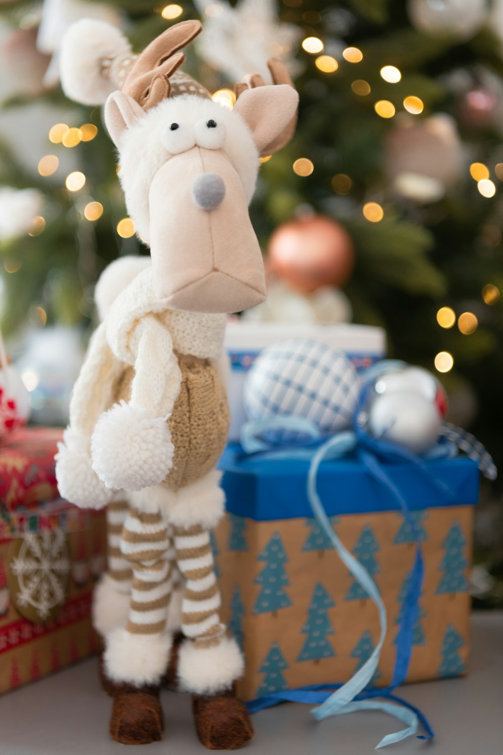 a stuffed animal next to a christmas tree