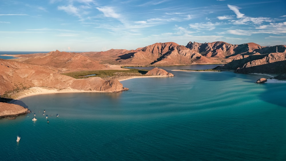 a body of water with mountains in the background