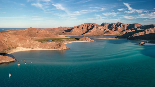 a body of water with mountains in the background