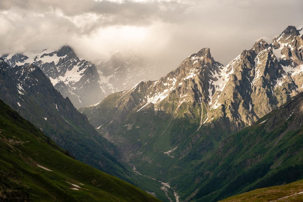 a mountain range with clouds