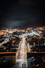 A nighttime cityscape of Carlisle with car headlights illuminating the streets.