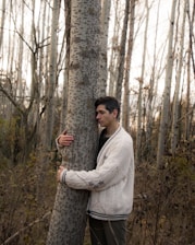 a person standing next to a tree