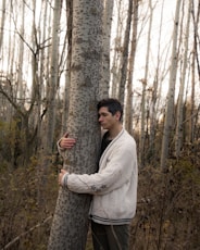 a person standing next to a tree