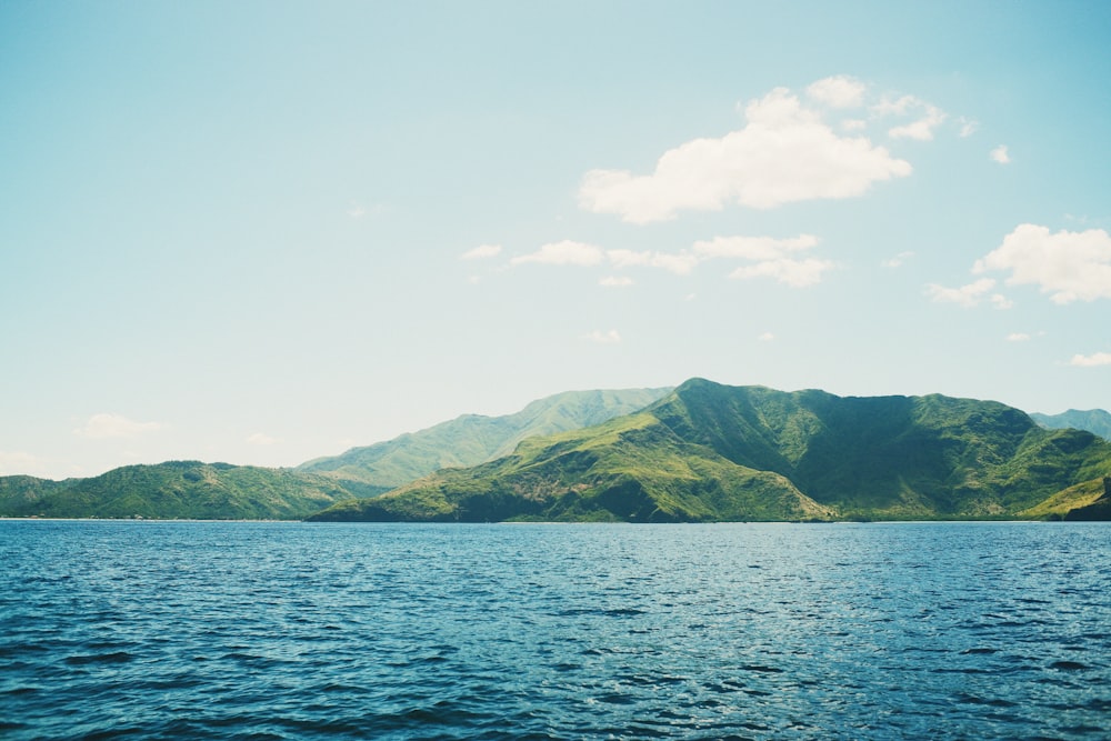 a body of water with hills in the background