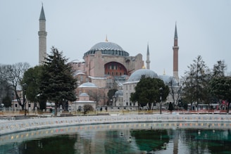 a large building with towers and domes with Hagia Sophia in the background