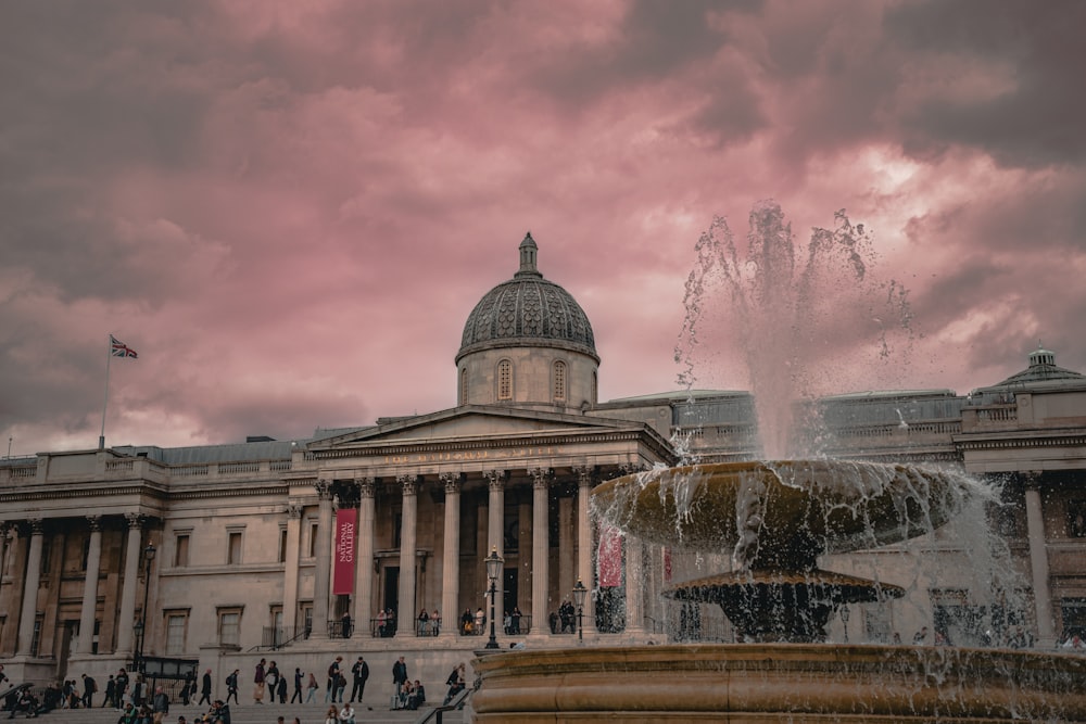 a large building with a fountain in front of it