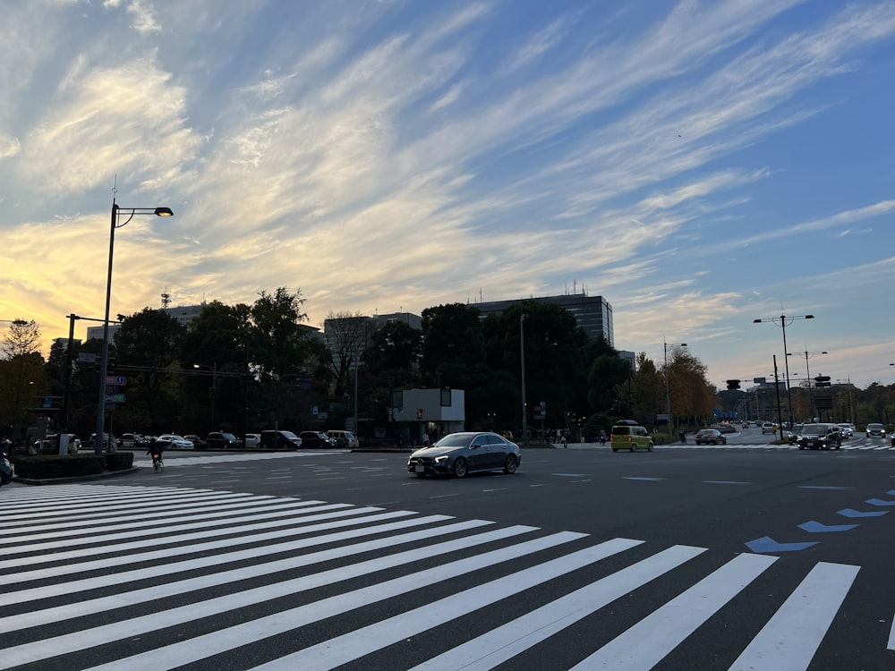 a street with cars and trees on the side