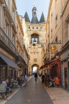 a group of people sitting on the sidewalk in a city