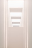 Minimalist stage design featuring geometric shapes and soft lighting.
