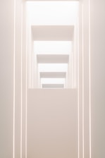 A sleek, minimalist architectural blueprint illuminated by soft golden light.