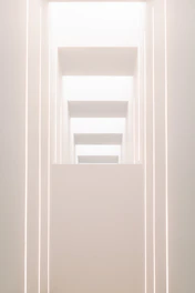 A sleek, dark-toned architectural model illuminated by soft gold lighting, reflecting modern luxury and minimalist design ethos.