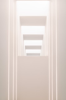 A sleek, minimalistic architectural structure bathed in soft futuristic lighting.