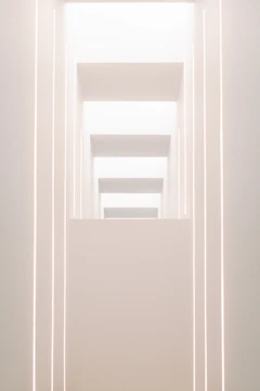 Minimalist exhibition stand with refined lighting and structural precision.