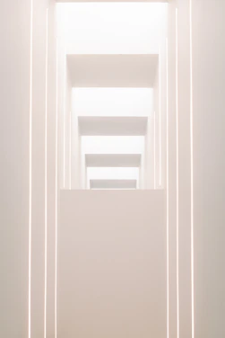 Minimalist cultural event space with strong linear design and warm lighting.