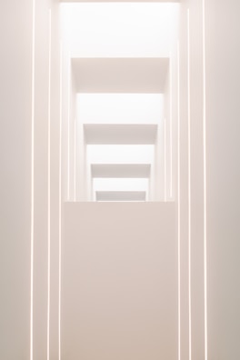 Minimalist stage design featuring geometric shapes and soft lighting.