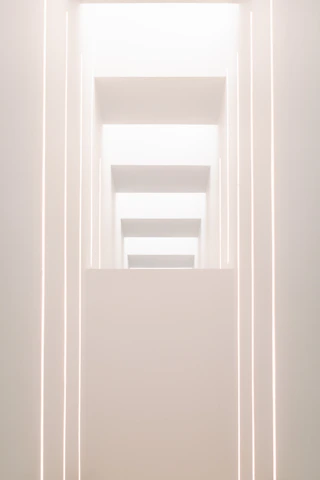 A sleek, dark-toned architectural model illuminated by soft gold lighting, reflecting modern luxury and minimalist design ethos.