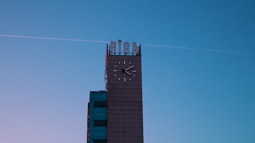 a clock tower next to a skyscraper