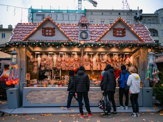 a group of people standing outside a building with a clock on it