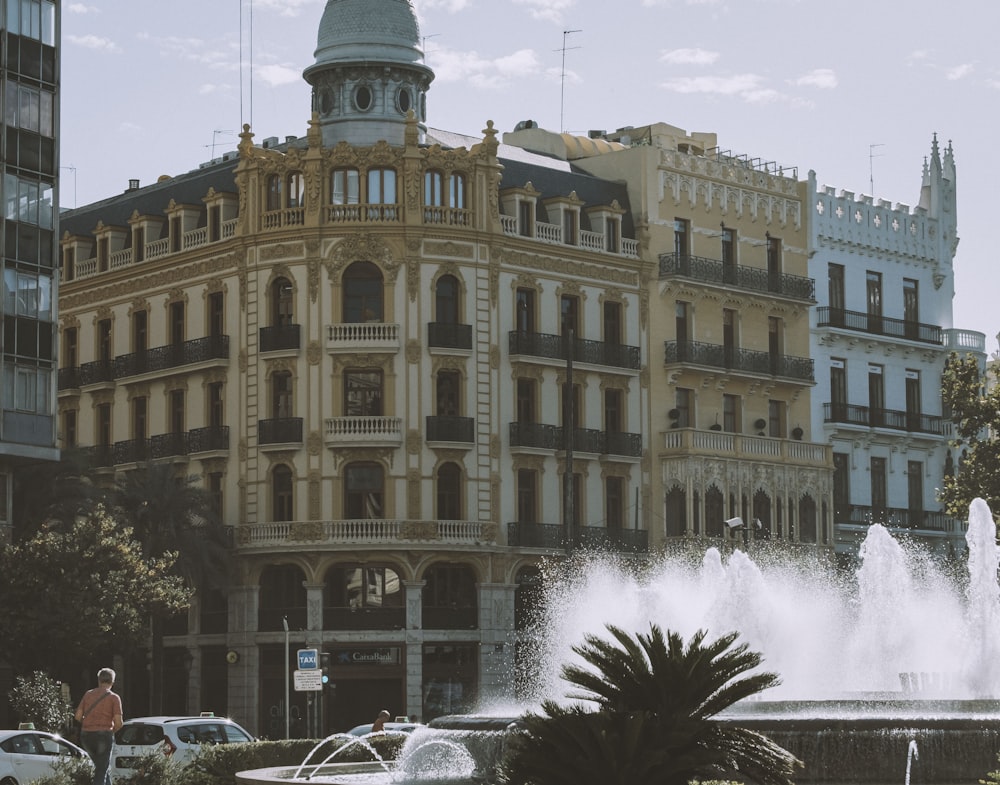 a large building with a fountain in front of it