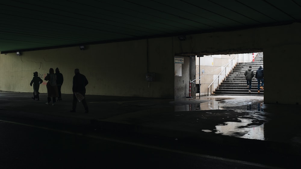 people walking in a dark room