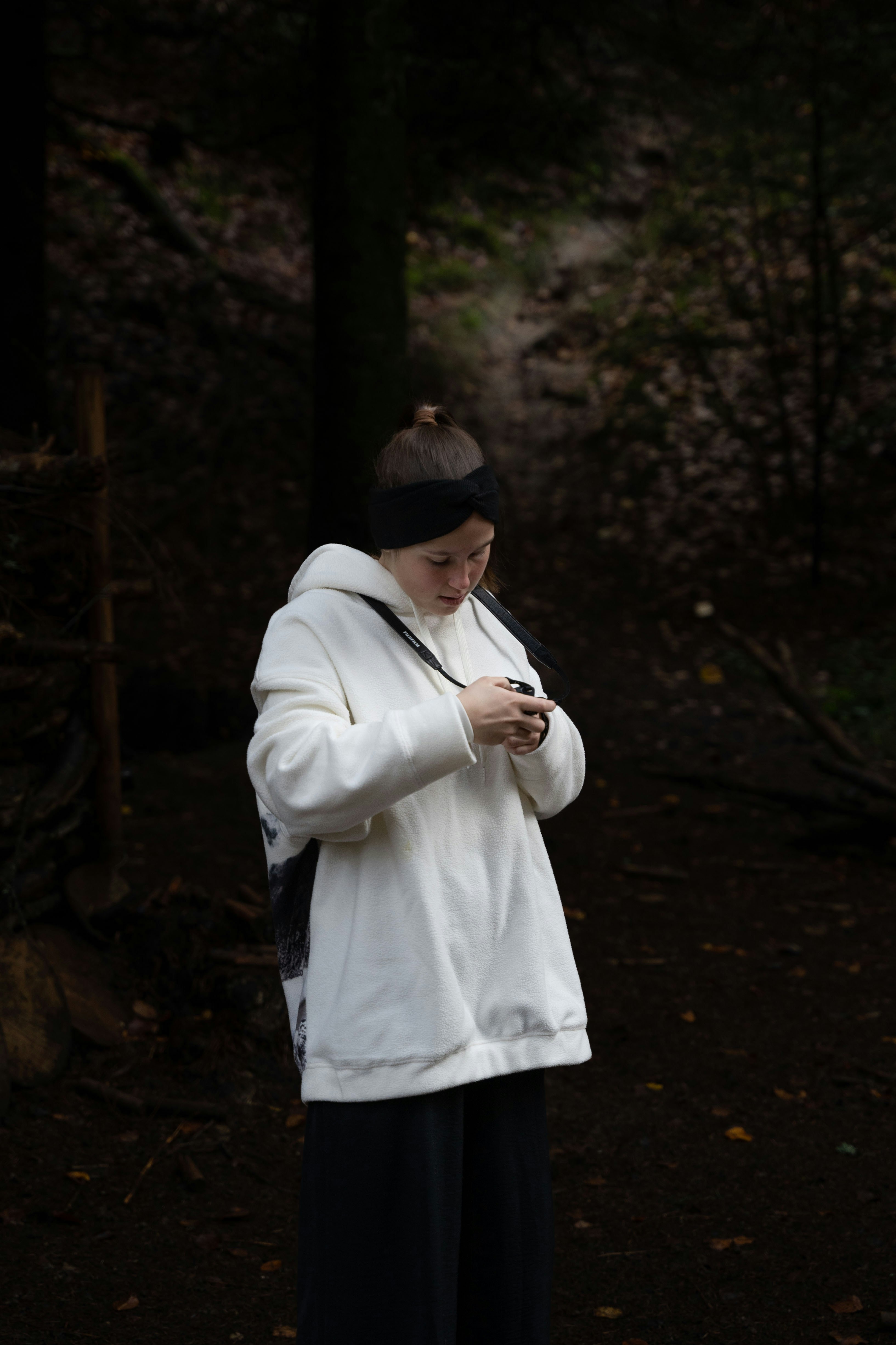 a person in a white coat looking at the phone