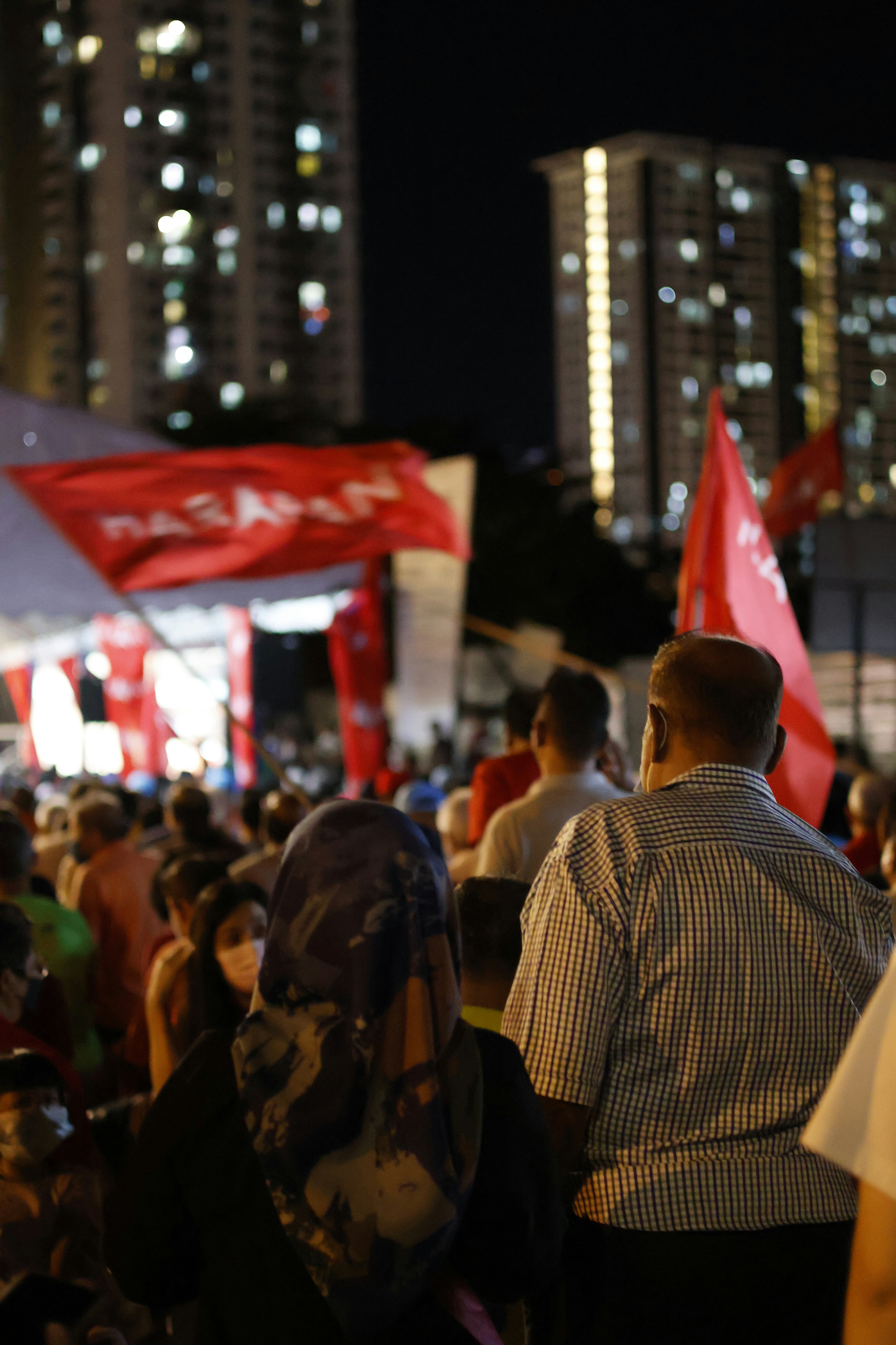 a crowd of people holding flags