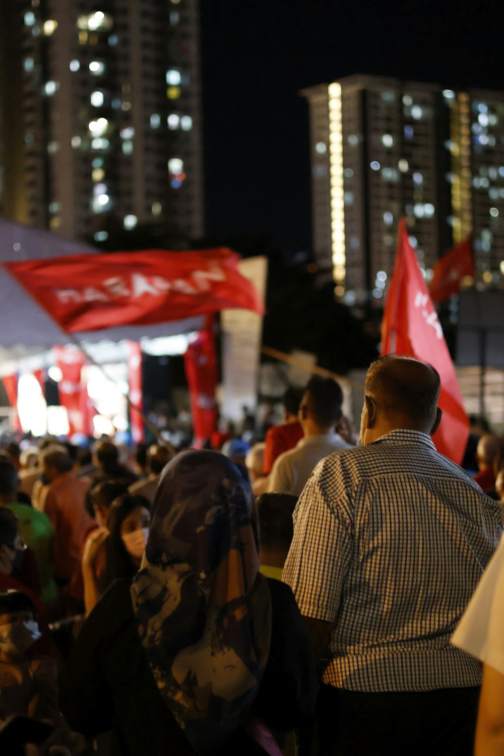 a crowd of people holding flags