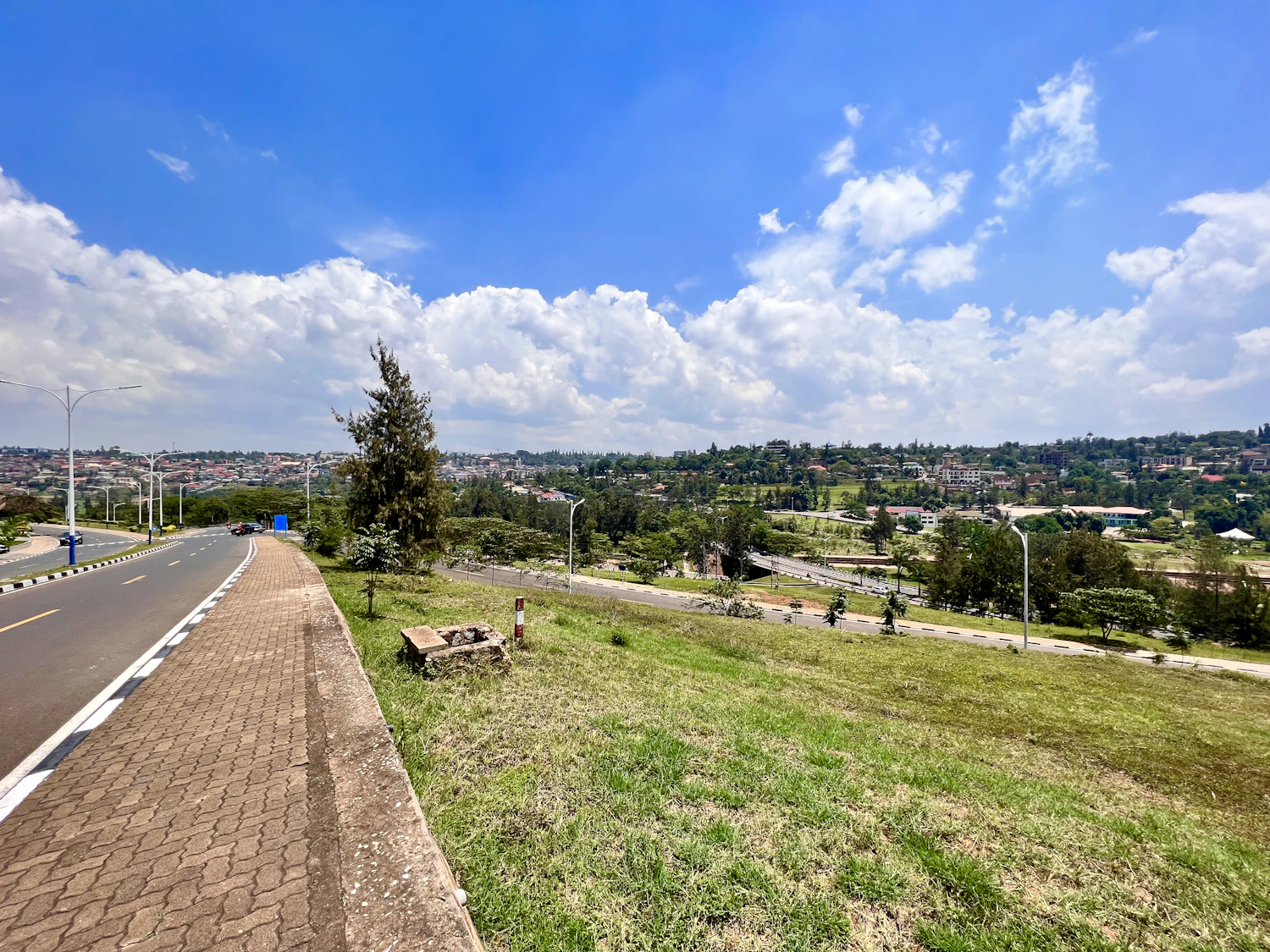 A green urban road overlooking Kigali