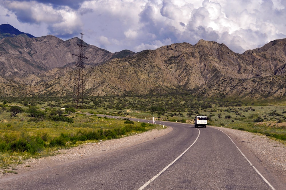 a car driving on a road in the mountains