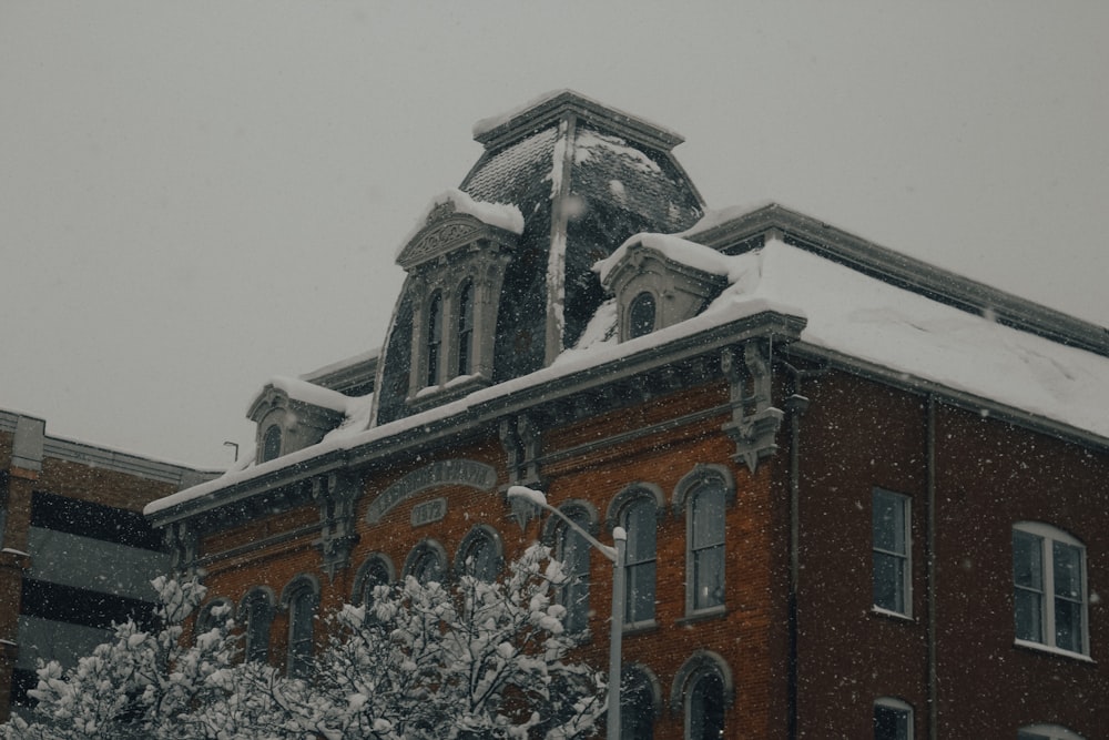 a brick building with snow on the roof