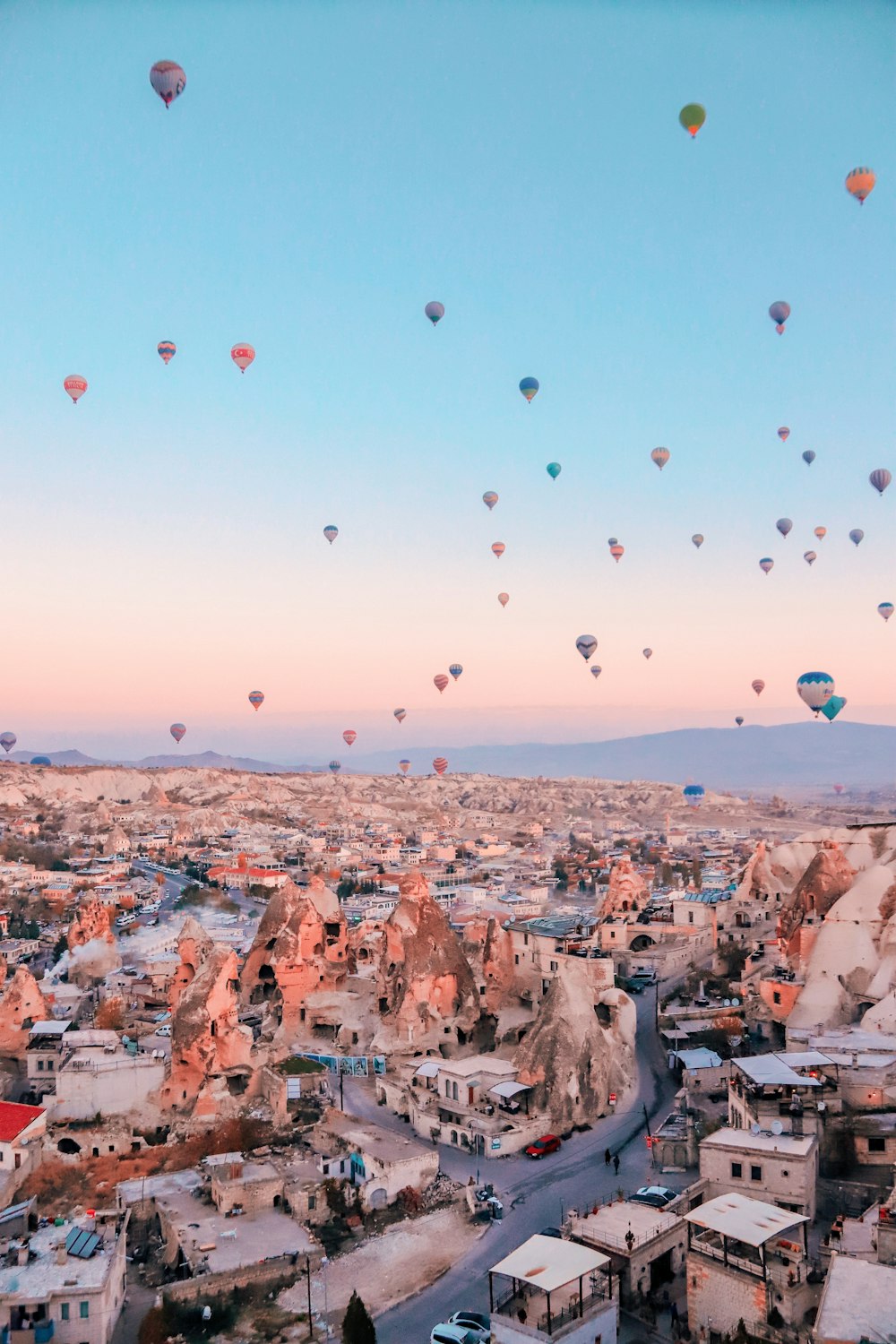 a group of hot air balloons in the sky above a city