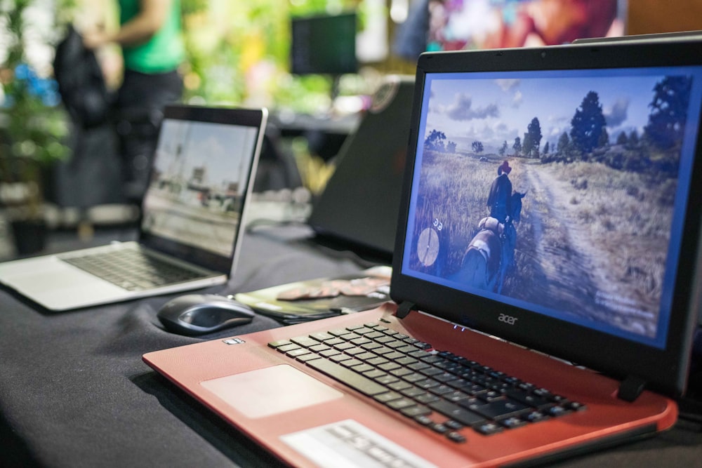 a couple of laptops sit on a table