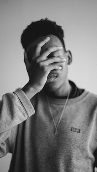 a man with his hand on his face