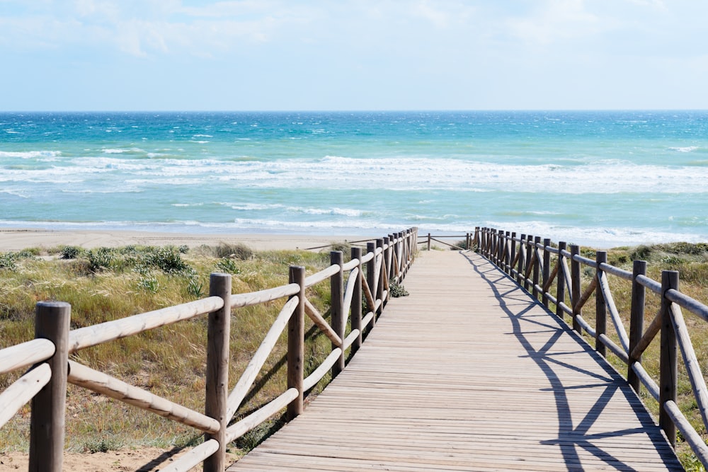 a wooden walkway to a beach