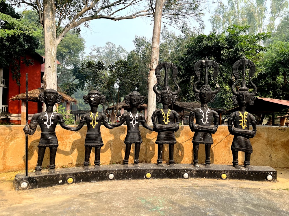 a group of statues of men in black uniforms