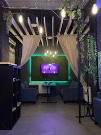 Futuristic neon-lit hotel lounge with multiple TVs showing family-friendly streaming content.