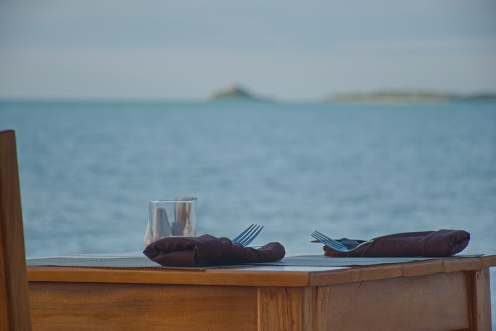 a person's feet on a table with a glass of water