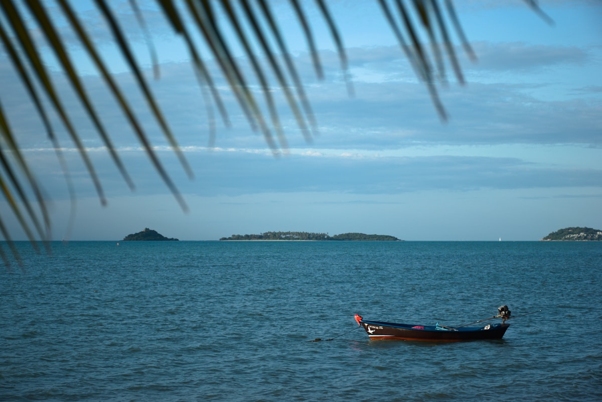 Koh Samui February — longtail boat on crystal-clear turquoise water in dry season