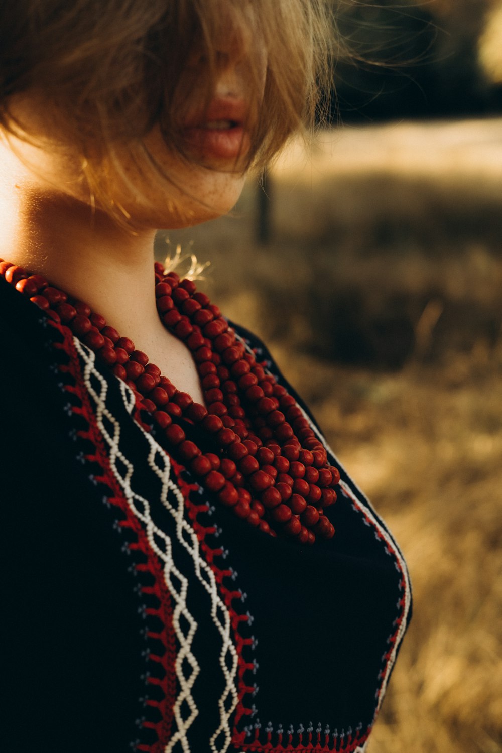a woman wearing a red and black scarf