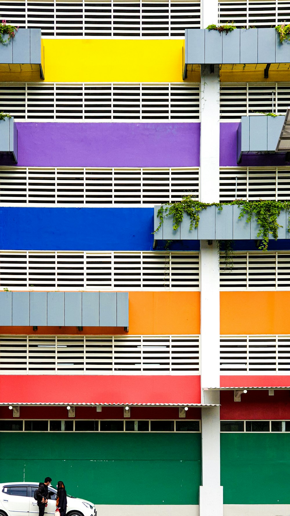 a few people walking in front of a building