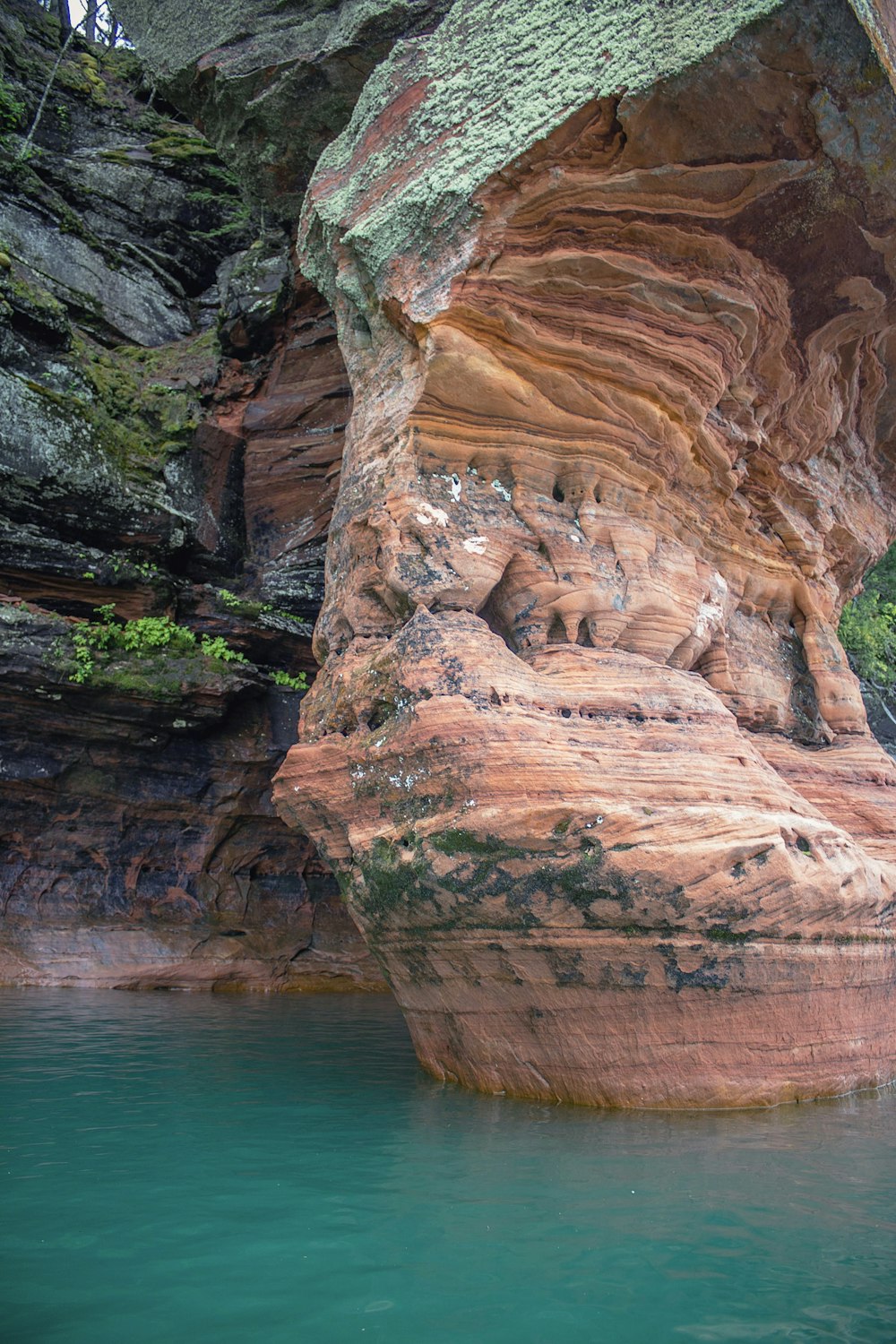 a cliff with a body of water below