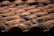 Rows of terracotta roof tiles are neatly aligned, with visible signs of weathering and aging. The tiles have a natural reddish-brown color with patches of dark discoloration, possibly due to moss or dirt.