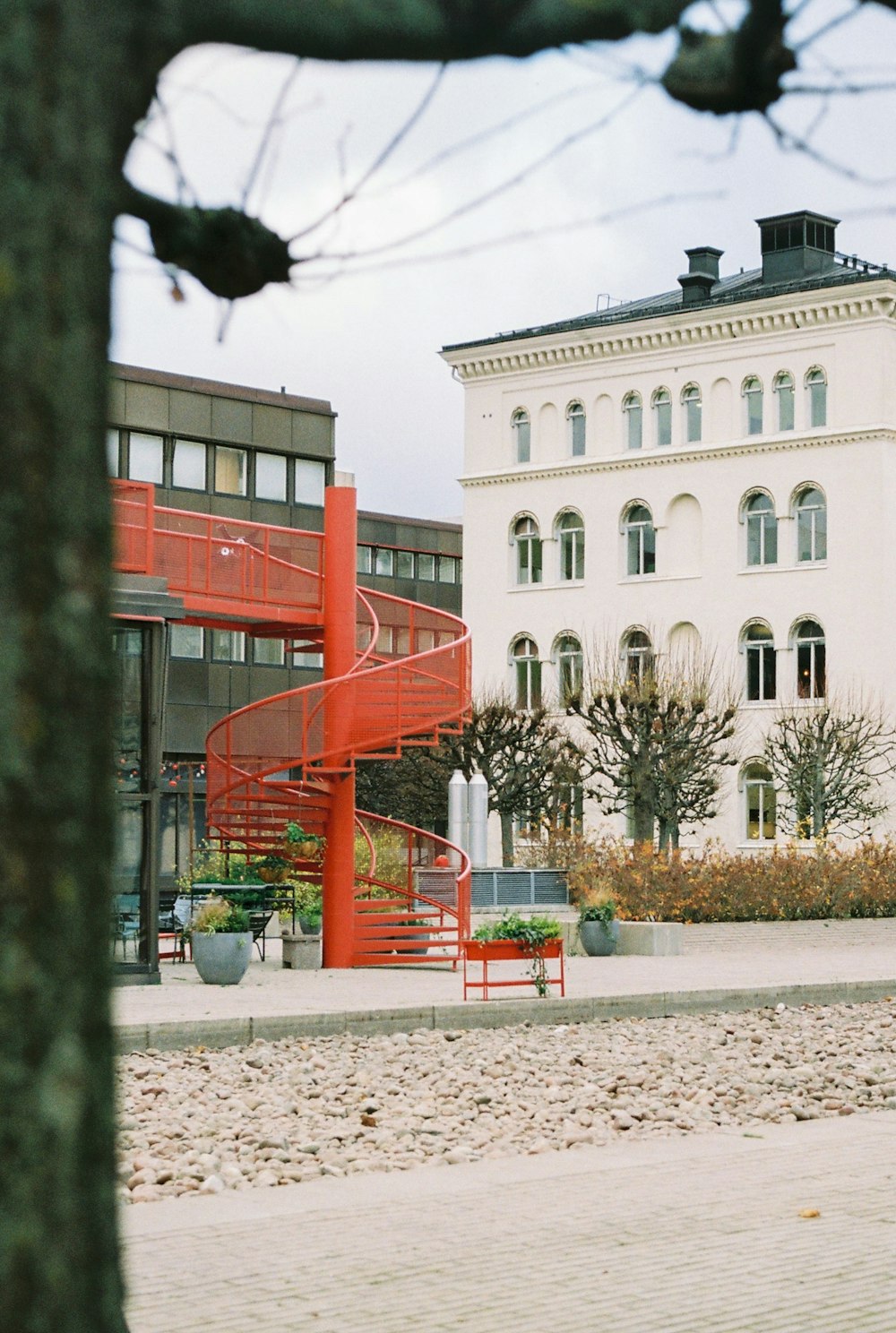 a red slide in front of a building